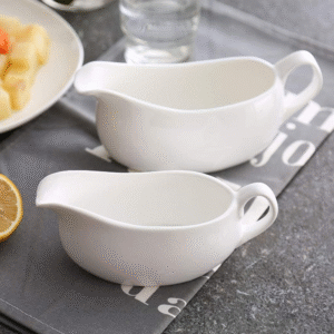 Set of 2 white porcelain gravy boats with handles