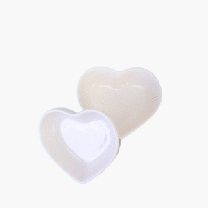 Two white ceramic heart shaped dip bowls