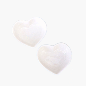 Two white ceramic heart shaped dip bowls