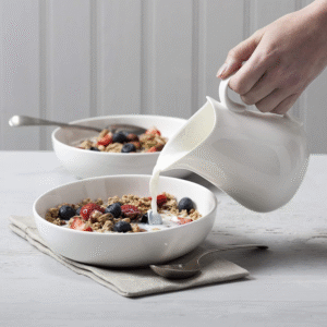 White porcelain ceramic milk jug for coffee and tea