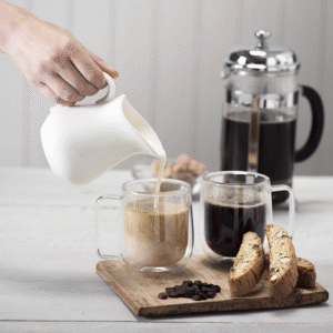 White porcelain ceramic milk jug for coffee and tea