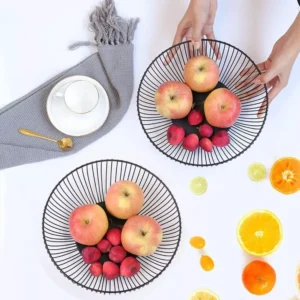 Two black metal wire fruit bowl stands with banana hooks