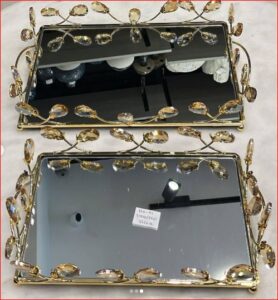 Gold toned mirrored serving tray with leaf-patterned edge
