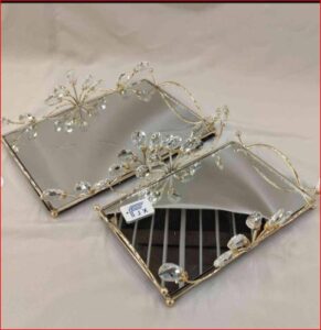 Gold toned mirrored serving tray with leaf-patterned edge