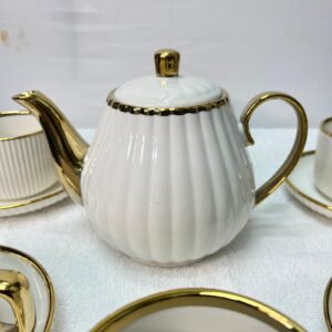 Luxury white ceramic tea set with gold handles and teapot