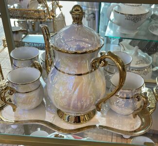Luxury porcelain teapot set with gold accents and six teacups