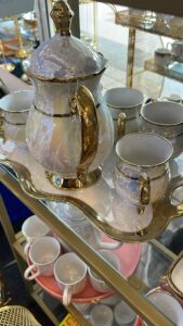 Luxury porcelain teapot set with gold accents and six teacups